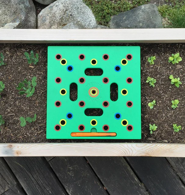A seeding square centered in a narrow garden bed.
