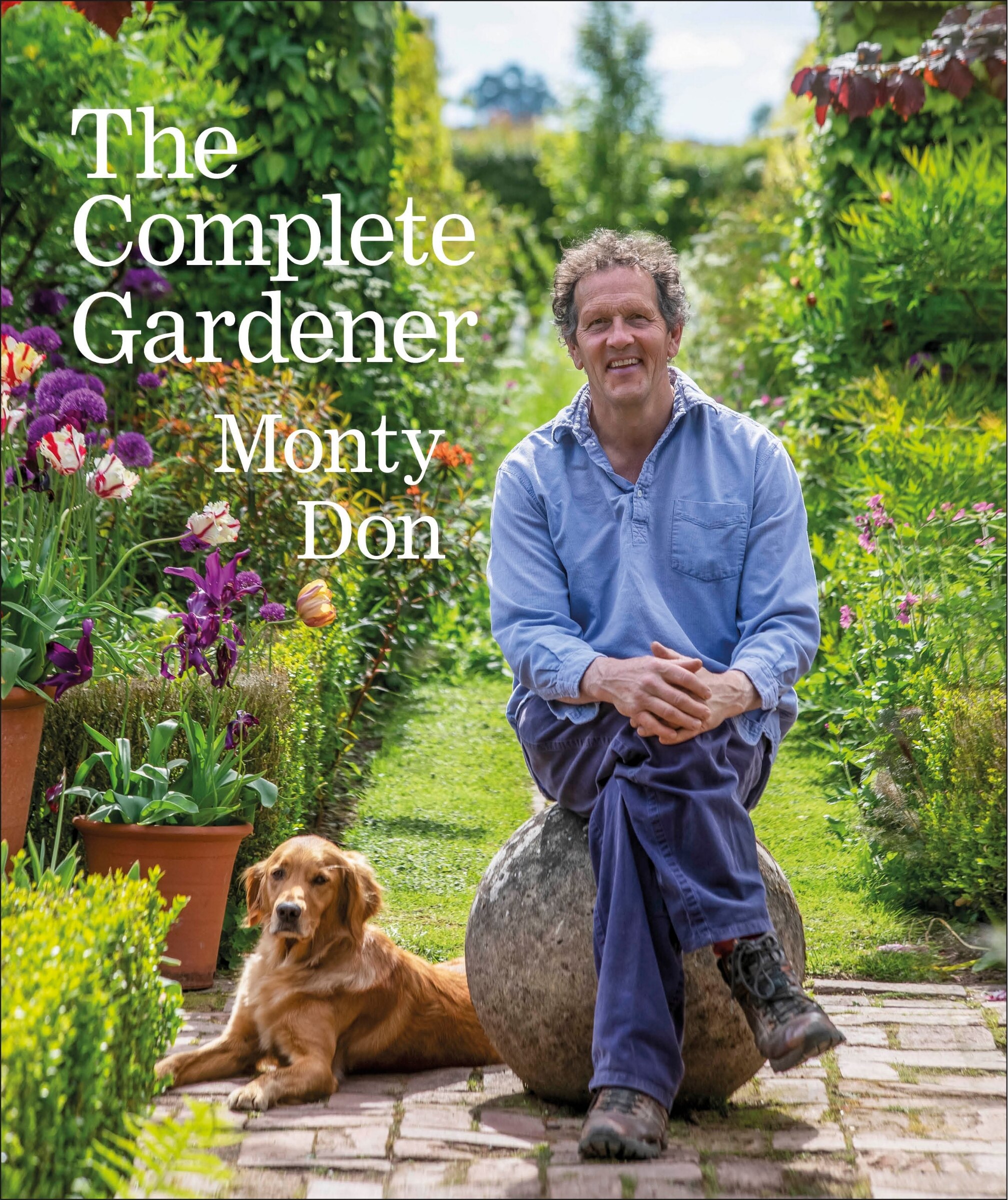 A gardener sits with a golden retriever next to him, a lush garden in the background.